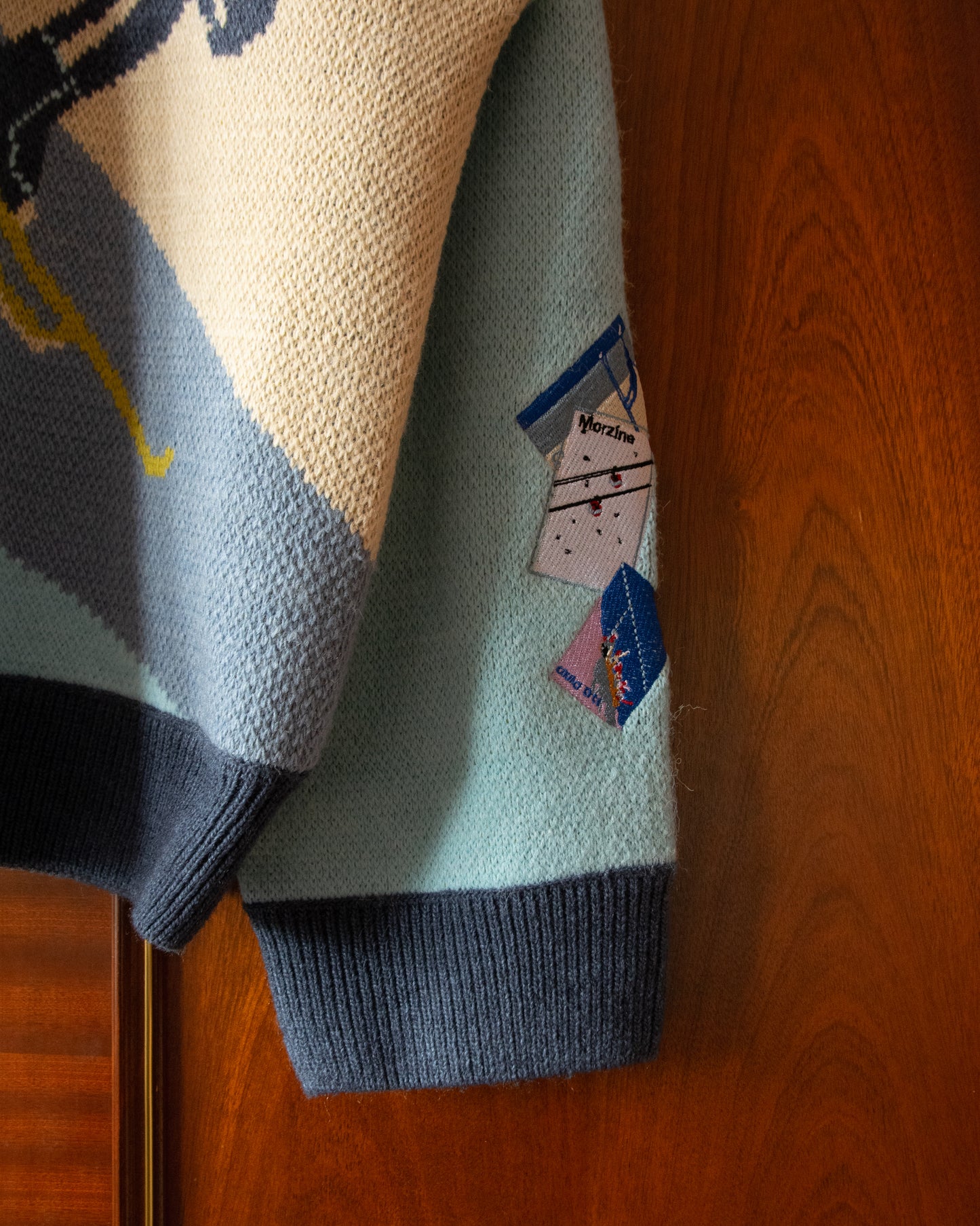 KNITTED SKI JUMPER WITH EMBROIDERED POSTCARDS
